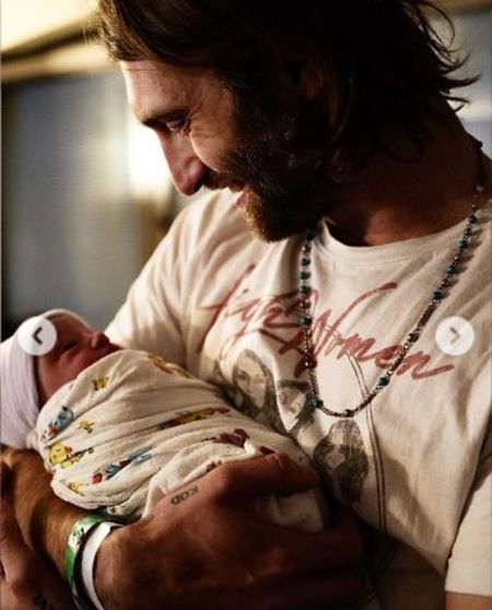 Papa Ryan holding his baby boy.